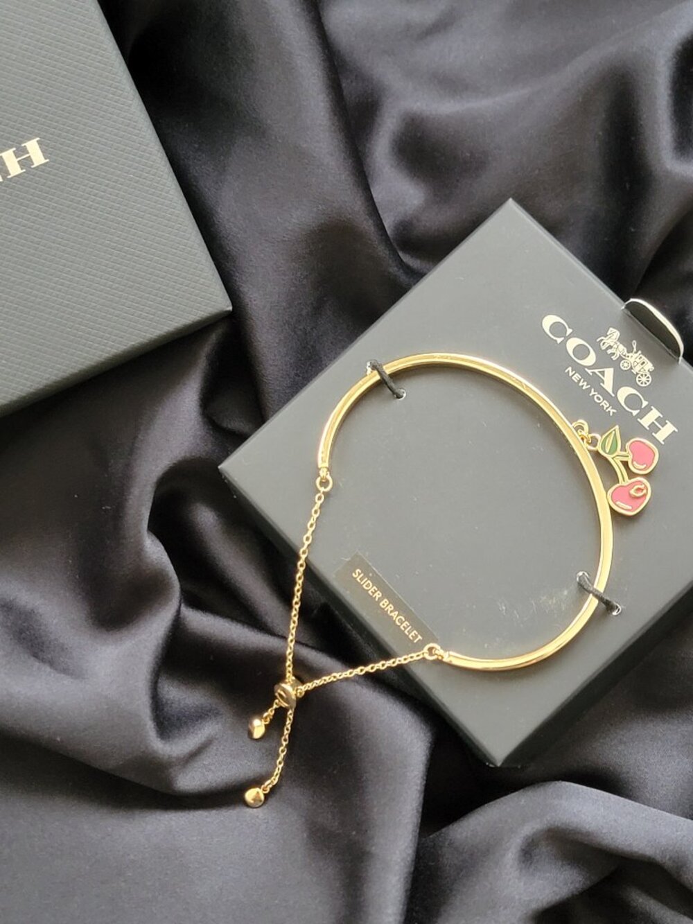 COACH SLIDER CHERRY BANGLE BRACELET
